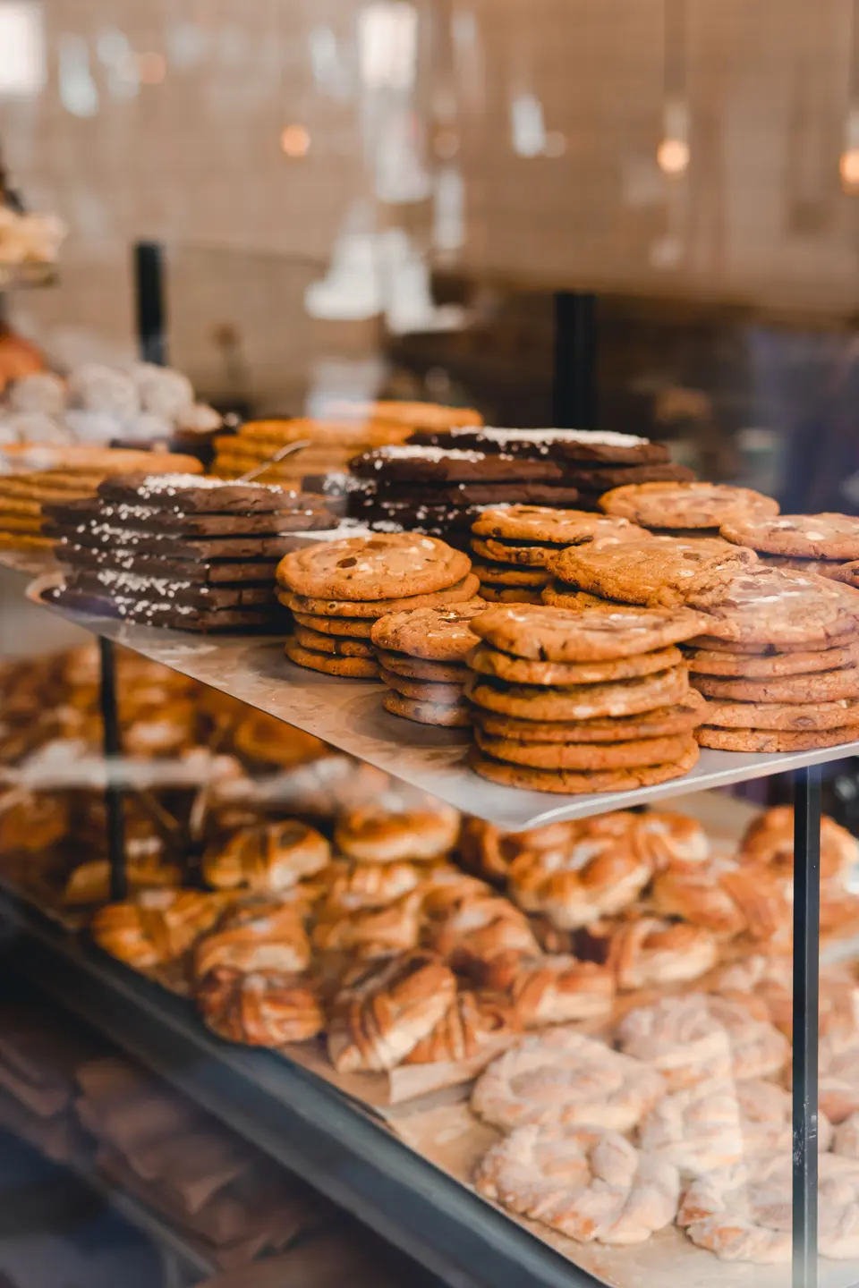 Stacks of cookies and pastries in a bakery display case