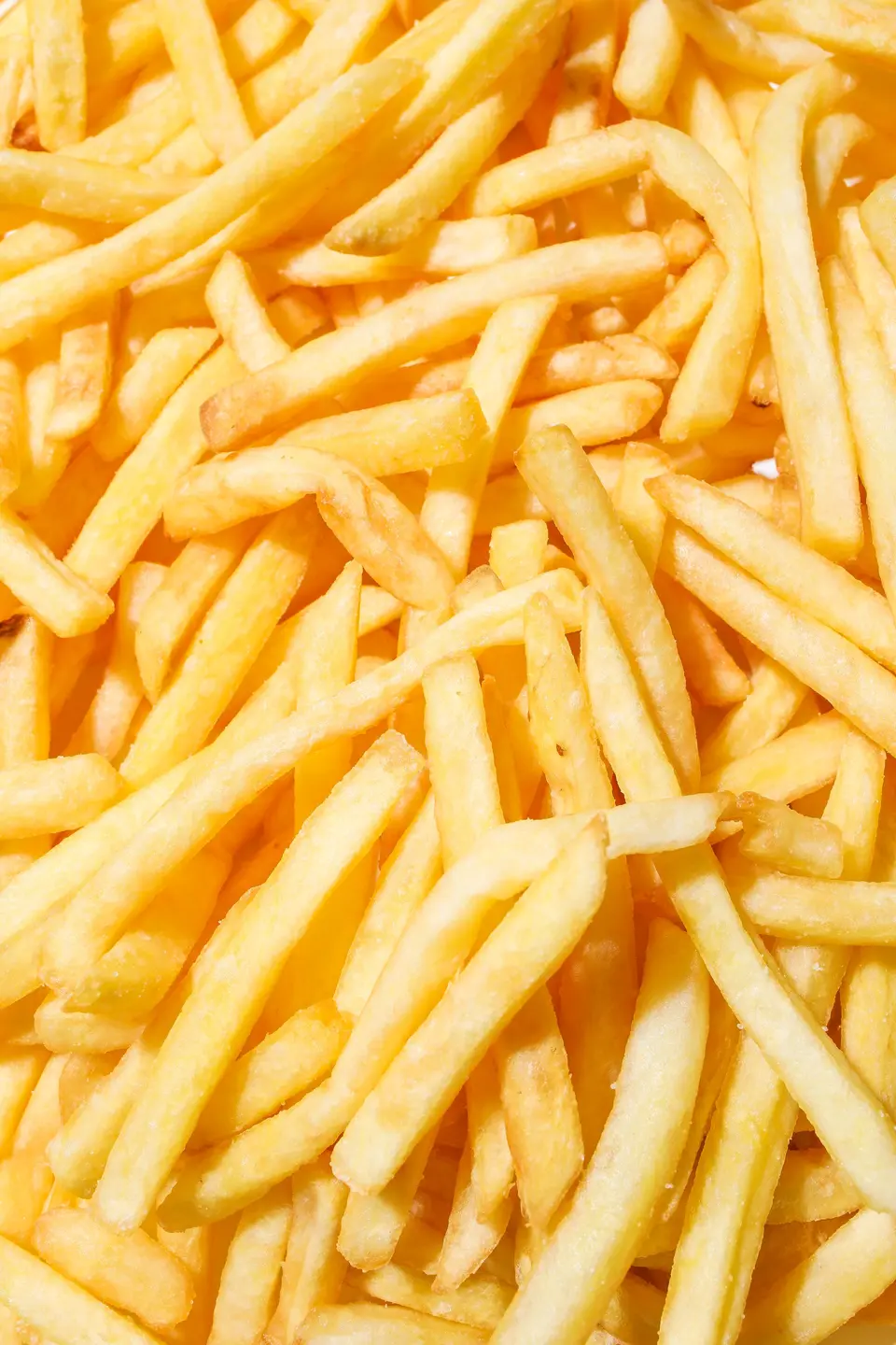 A heap of golden french fries, close up